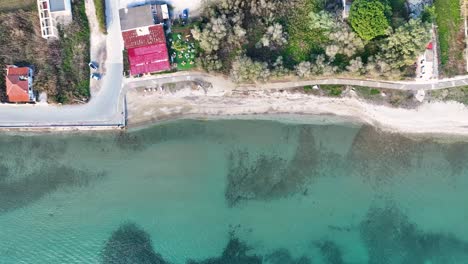 Top-down-aerial-footage-of-the-coastline-in-Marathon,-Greece