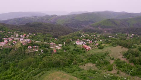Panning-above-the-Tsarichina-Village,-showing-the-surrounding-hills,-mountains,-trees,-and-the-neighborhood-of-a-place-known-for-its-extra-terrestrial-sightings-in-Bulgaria