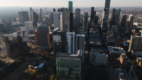 High-angle-circling-drone-shot-of-the-skyline-of-Houston,-sunny-day-in-Texas,-USA
