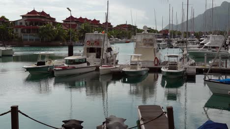 Time-lapse-of-docking-yachts-and-boats-at-eden-island-marina,-villas-at-the-background-Mahe,-Seychelles,-25-fps