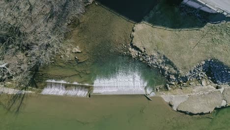 An-Aerial-Downward-View-of-a-Man-Made-Waterfall-for-a-Mill,-on-a-Sunny-Day