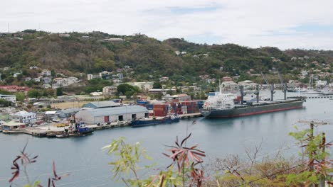 Container-ship-in-port-on-tropical-island,-Grenada