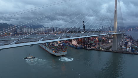 Container-Ship-passing-Stonecutter-bridge-at-dusk
