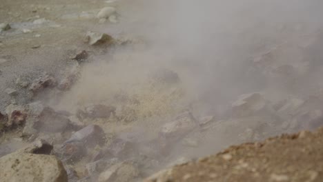 Steaming-methane-and-mineral-pool-bubbles-and-froths-against-light-rocks-and-mud