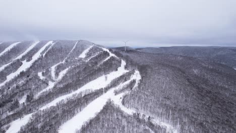 Skiers-and-snowboarders-race-downhill-on-ski-slopes-of-a-snow-covered-mountain-in-the-Appalachian-Mountains-of-Massachusetts