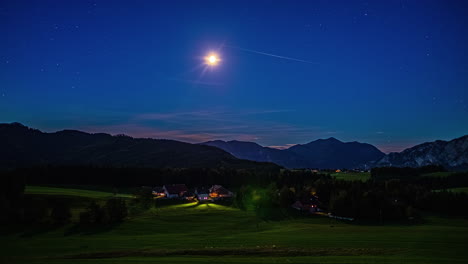 Sunrise-time-lapse-over-Austrian-mountains-with-clear-blue-sky-and-moon