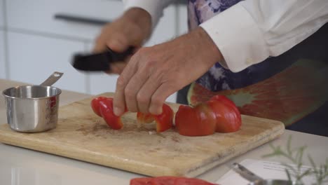 Cutting-red-bell-peppers-and-putting-it-into-a-cup-to-add-to-food-processor-creating-a-raw-vegan-burger