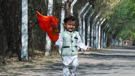 kid-walking-holy-saffron-flag-with-lord-rama-idol-at-day-from-flat-angle