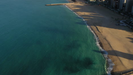 Aerial-view-from-the-footbridge-to-wall-of-buildings-located-in-front-of-the-beach,-Fortaleza,-Ceara,-Brazil
