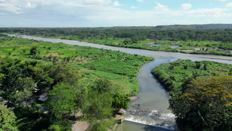 Rural-Creek-Flows-Into-Larger-River-Near-Yogyakarta-Indonesia