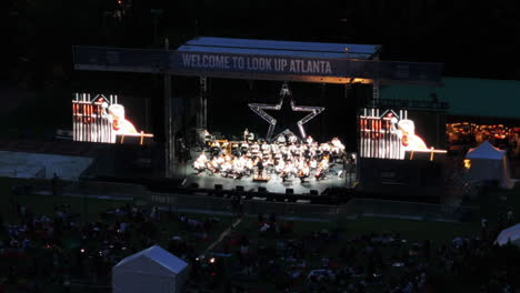 Aerial-view-of-orchestra-performing-on-open-air-event-in-park
