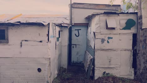 Strolling-past-makeshift-structures-crafted-from-diverse-materials-like-aluminum-and-sturdy-paper,-conjuring-the-essence-of-favela-living