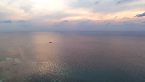 Tropical-coastline-with-sandy-beach-and-ocean-horizon-in-Thailand,-aerial-view