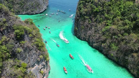 Boats-entering-scenic-Pileh-Lagoon-of-Phi-phi-island,-Aerial