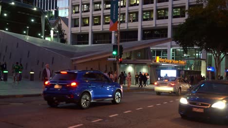 Static-shot-capturing-cars-and-buses-moving-on-the-road-with-people-waiting-at-the-traffic-lights-on-Albert-and-Adelaide-street-in-Brisbane-city-towards-King-George-Square-busway-station