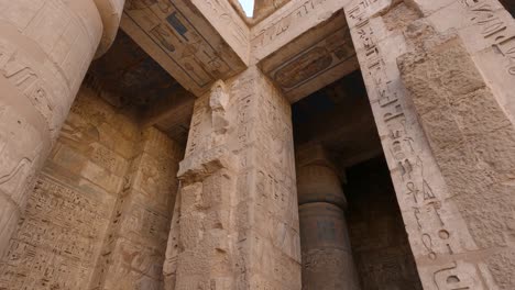 Tilt-down-shot-of-carved-columns-from-Medinet-Habu-temple,-Luxor