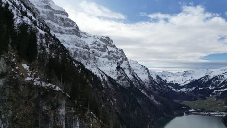 Klöntalersee-Schweiz-Seitenflug-Zeigt-Große-Schneebedeckte-Berge
