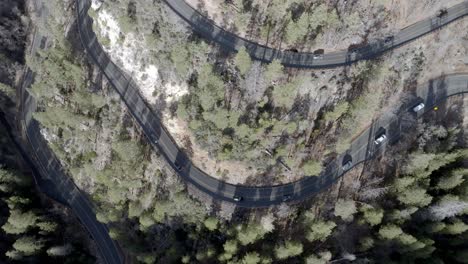 Switchback-road-with-cars-driving-on-Highway-89-A-in-Sedona,-Arizona-with-drone-video-overhead-moving-down