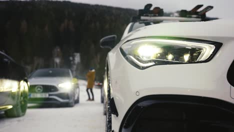 Close-up-of-car-front-bumper-and-bright-headlight-with-lens-reflection