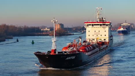 Small-liquid-tanker-sailing-on-a-dutch-river-at-sunrise