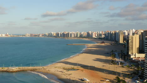 Aerial-view-of-the-ocean,-beach-and-footbridge,-Fortaleza,-Ceara,-Brazil