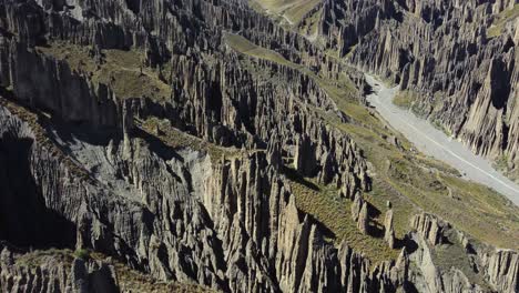 Flyover-dramatic-geology,-valley-of-rocks,-eroded-spires-in-Bolivia