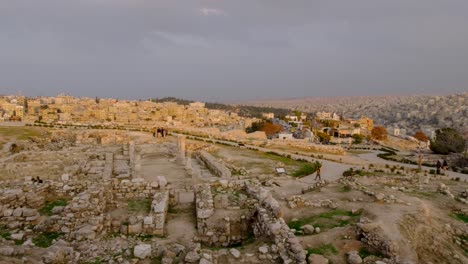 Crowds-of-people,-tourist-and-locals,-visiting-and-exploring-the-Amman-Citadel-historical-archeological-site-with-a-scenic-view-of-the-Jordanian-capital-city