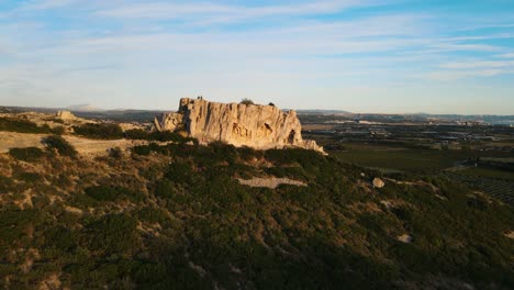 Toma-Aérea-En-órbita-De-Una-Formación-Rocosa-Rodeada-De-Viñedos-En-Francia.