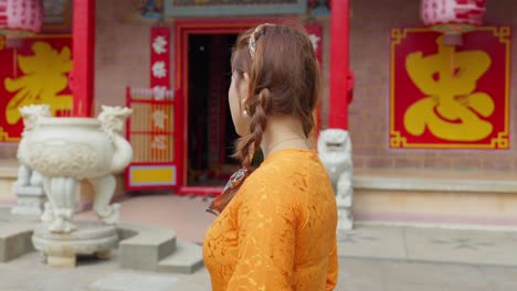 Close-up-of-an-Asian-girl-in-national-costume-walking-to-visit-a-pagoda