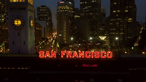 Aerial-view-over-the-illuminated-San-Francisco-sign-and-streets-at-Embarcadero