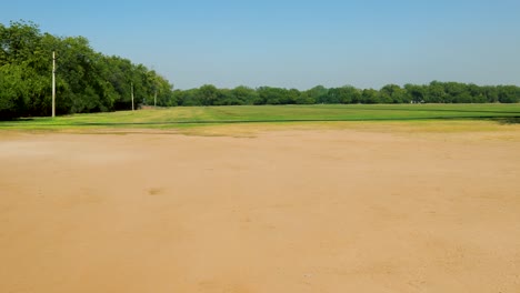 isolated-green-playing-ground-with-bright-blue-sky-at-day-from-flat-angle