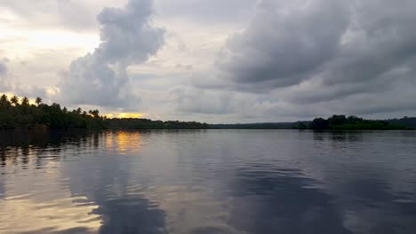 Exotic,-idyllic-view-of-tropical-island-in-the-remote-Shortland-Islands-of-Western-Province-of-the-Solomon-Islands-with-golden-sunset-sky-on-a-cloudy-day