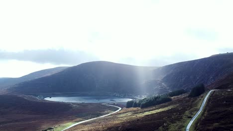 A-picturesque-timelapse-of-the-Wicklow-mountains-and-Lough-Nahanagan-as-the-sun-rays-shine-through-the-clouds-on-a-beautiful-day,-Dublin,-Ireland