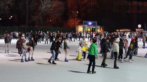 People-enjoying-evening-ice-skating-at-City-Park-Ice-Rink-Budapest,-Hungary