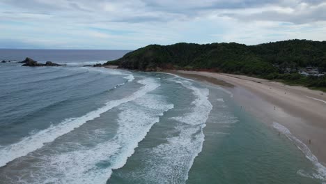 Ocean-Waves-Crashing-On-Sandy-Shore-Of-Broken-Head-Beach-In-Byron-Bay,-NSW,-Australia---Aerial-Shot