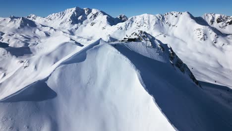 a-drone-flies-around-a-big-snow-covered-mountain-in-the-alps