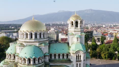 Golden-dome-beautiful-cathedral-in-Sofia,-Bulgaria,-aerial-orbit,-city-skyline