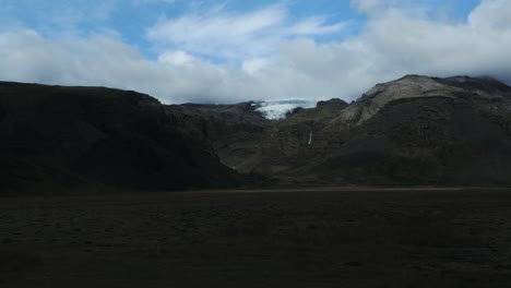 Hyperlapse-of-glacier-ice-tongue-between-volcanic-mountain-range-scenery,-Iceland-nature-view-on-sunny-day