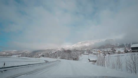 POV-video-of-driving-through-Norway's-Western-Fjords-in-winter,-showcasing-a-journey-along-snowy-roads