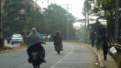 Traffic-and-people-on-the-Briquetterie-side-road,-hazy-day-in-Yaounde,-Cameroon