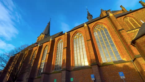 Side-of-historic-Catholic-church-of-German-village-Straelen-in-winter-sunlight