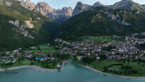 Beautiful-Molveno-township-in-Italy-Dolomites,-high-angle-drone-view