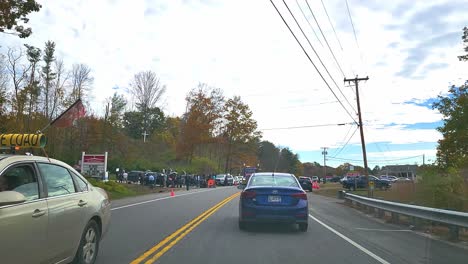 POV-car-driving-on-road-arriving-at-scene-of-mass-shooting-in-Lewiston,-USA