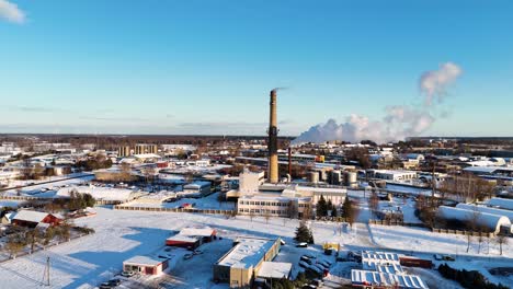 Smoke-fumes-coming-out-of-Industrial-building-in-the-city-in-winter,-Lithuania,-Germany