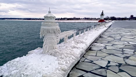 Aerial-view-of-ice-covering-the-Saint-Joseph-Lighthouse,-winter-in-Michigan,-USA