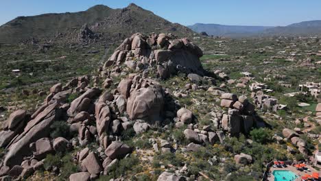 Vast-stone-desert-landscape-in-Arizona,-aerial-orbit-around-rocky-hill