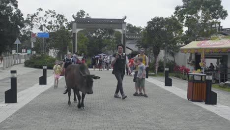 Ngong-Ping-Village-main-plaza-as-tourists-and-visitors-take-pictures-of-a-sacred-cow-during-an-overcast-day
