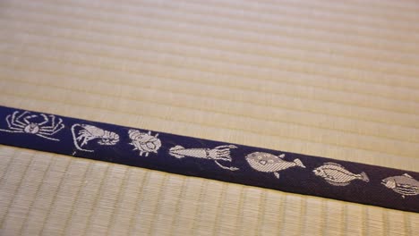 Tatami-Mat-Close-Up-Pan-Shot,-Traditional-Japanese-Flooring-with-Ocean-Design