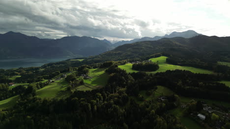 Aerial-drone-forward-moving-shot-over-green-vegetation-covering-mountain-range-on-a-cloudy-morning