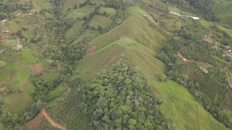 A-brief-ascent-up-the-ridges-of-a-mountain-in-Costa-Rica-featuring-the-green-landscape-and-red-dirt-paths